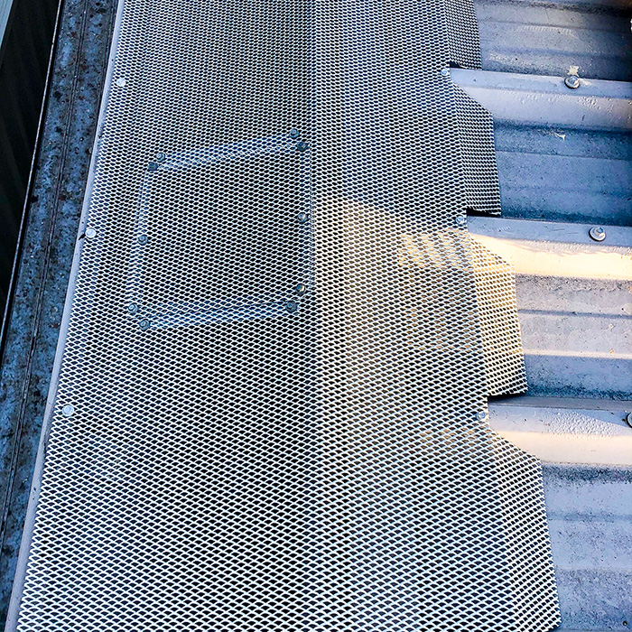  Access hatch in Gutter Guard mesh on a box gutter. 