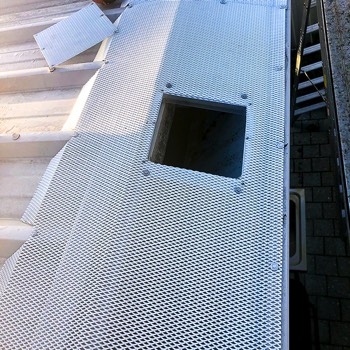  Access hatch in Gutter Guard mesh on a box gutter. 